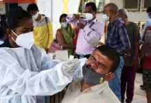 a healthcare worker collects the swab sample of a passenger for rt pcr testing at dadar station in 1623122406
